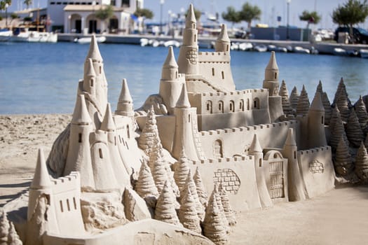 creative big sandcastle on the beach in summer blue sky