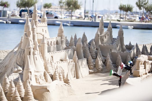 creative big sandcastle on the beach in summer blue sky