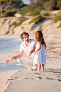 happy family father and daughter on beach having fun summer vacation