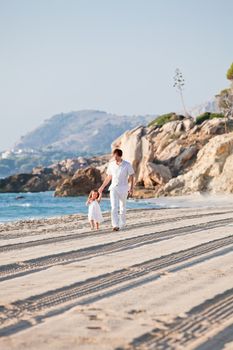 happy family father and daughter on beach having fun summer vacation