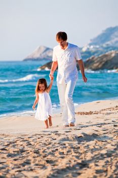 happy family father and daughter on beach having fun summer vacation