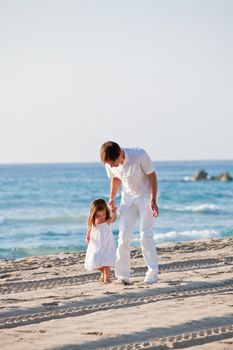 happy family father and daughter on beach having fun summer vacation