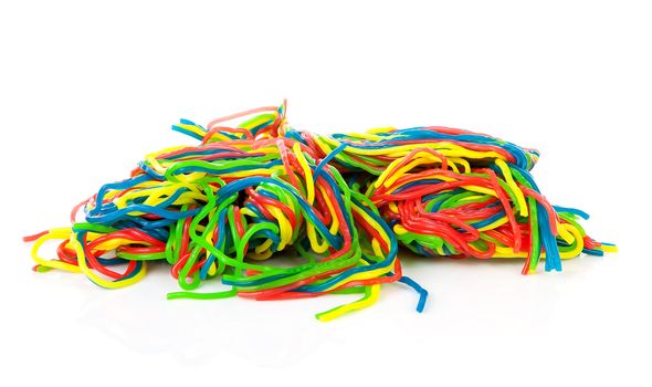 Pile of colorful fruit laces candy over white background