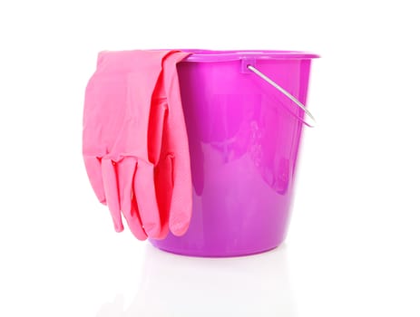 Purple bucket and household gloves over white background