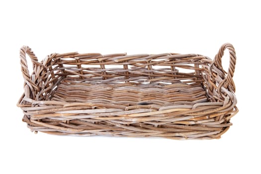 Big empty cane basket over white background