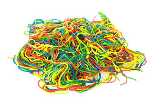 Pile of colorful fruit laces candy over white background