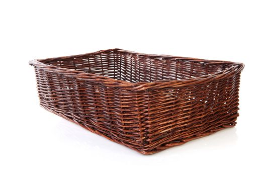 Big empty cane basket over white background