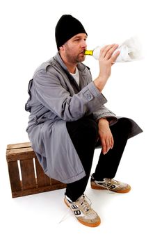 male homeless tramp with empty bottle over white background