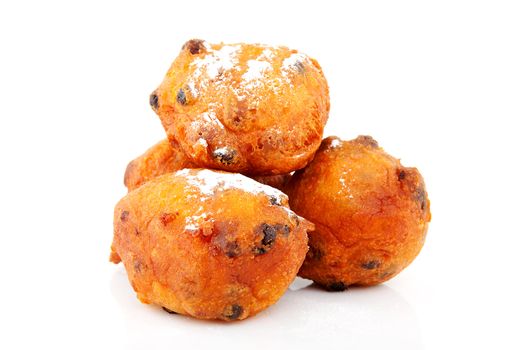 Pile of Dutch donut also known as oliebollen, traditional New Year's eve food isolated on white background 
