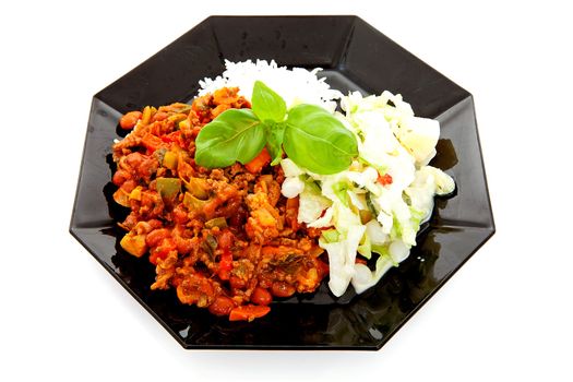 plate with delicious chilli con carne, rice and salad over white background