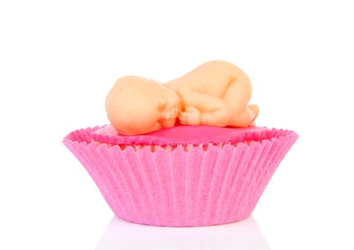 Pink Birth cupcake with marzipan baby over white background