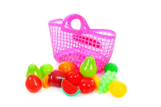 Pink plastic shopping bag with plastic grocery over white background
