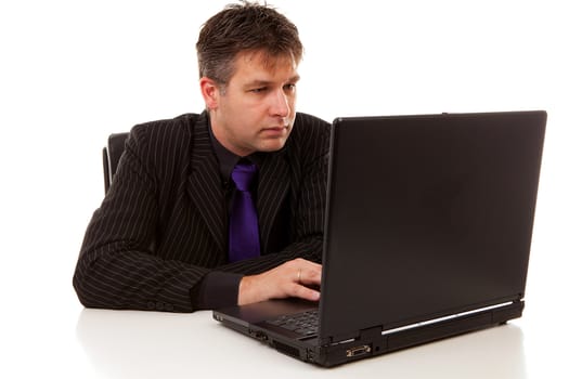 Businessman at work on laptop over white background