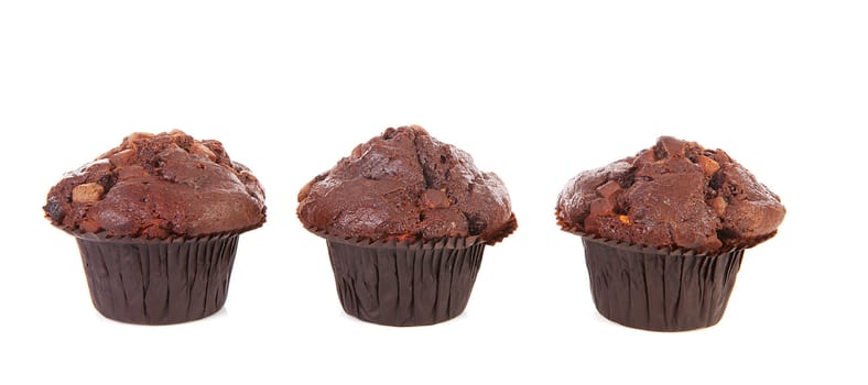 Three chocolate cupcakes isolated on white background