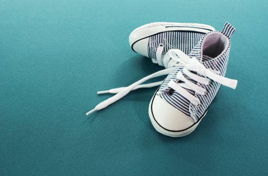 small baby sport shoes on blue background