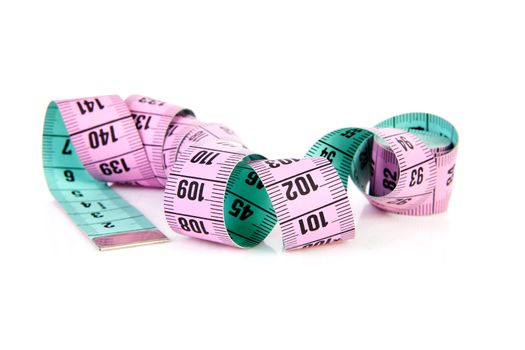 Rolled colorful measure tape over white background