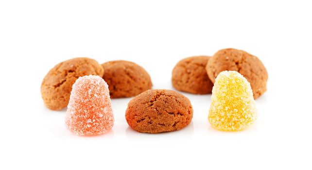 Couple of pepernoten (ginger nuts) and tumtum sweets for typical Dutch festivity at 5 december over white background