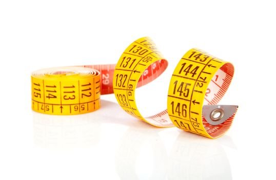 Rolled yellowl measure tape over white background