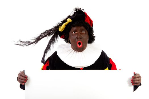 Zwarte piet ( black pete) typical Dutch character part of a traditional event celebrating the birthday of Sinterklaas in december over white background is holding empty text board