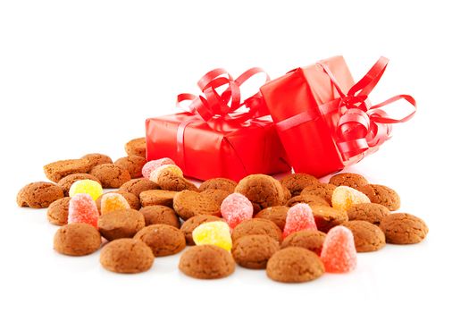Typical dutch sweets: pepernoten (ginger nuts) and presents for celebration at 5 december in the Netherlands over white background