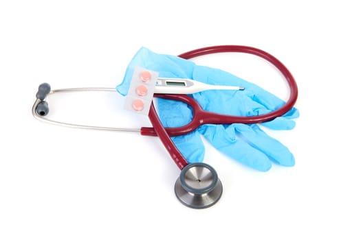 Medical tools with gloves, stethoscope, pills and thermometer over white background