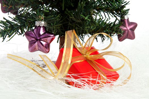 plastic christmas tree with purple stars and red present isolated on white background