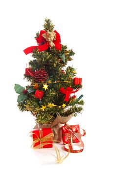 plastic christmas tree with red presents and decoration  isolated on white background