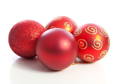 Four red christmas balls over white background