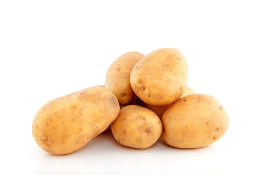 Stack of unpeeled potatoes over white background