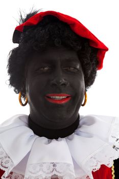 Portrait of laughing Zwarte piet ( black pete) typical Dutch character part of a traditional event celebrating the birthday of Sinterklaas in december over white background is pointing