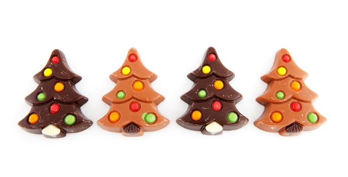 christmas chocolate candy in shape of tree over white background