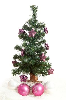 plastic christmas tree with purple stars and pink balls  isolated on white background