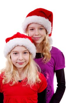 Two girl with christmas hat posing over white background