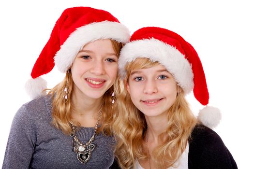 Two girl with christmas hat posing over white background