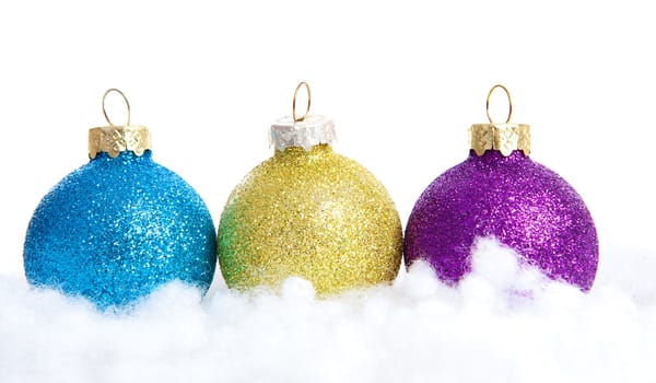 Colorful glitter Christmas balls over white background