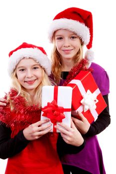 Two girl with christmas hat and presents posing over white background