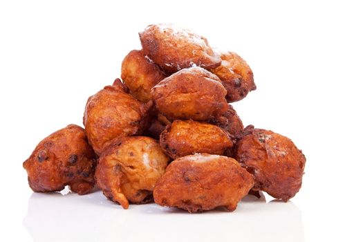 Pile of Dutch donut also known as oliebollen, traditional New Year's eve food isolated on white background 
