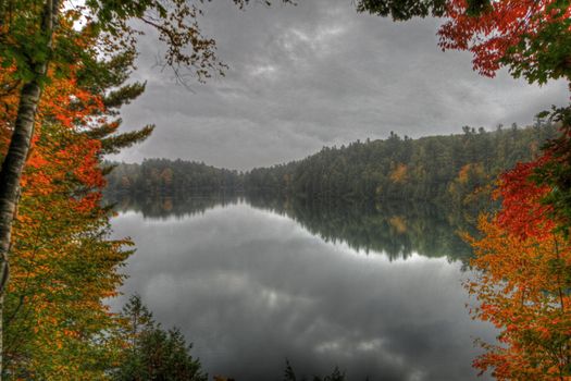 Fall foilage reflecting on Pink Lake in Gatineau Park