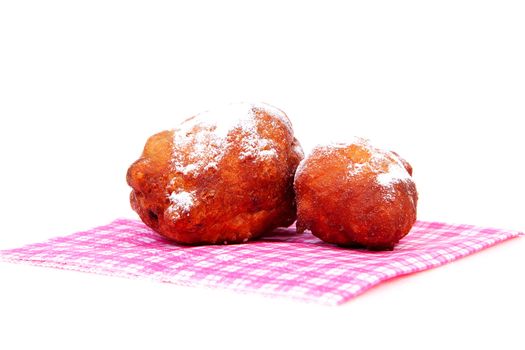 Two Dutch donut also known as oliebollen on napkin, traditional New Year's eve food isolated on white background