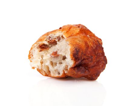Dutch donut also known as oliebollen with bite over white background
