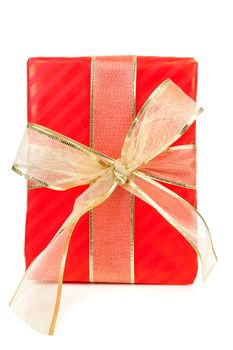 Big red present with golden ribbon over white background