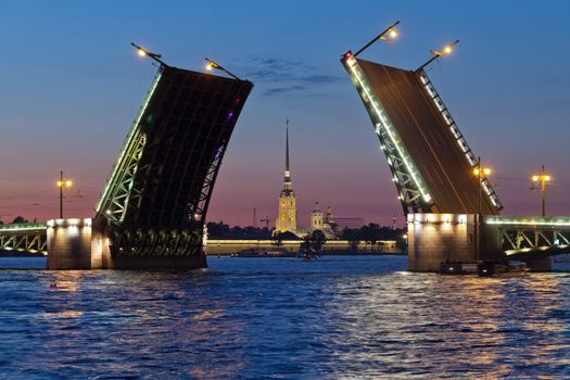 Classic symbol of St. Petersburg White Nights - a romantic view of the open Palace Bridge, which spans between - the spire of Peter and Paul Fortress