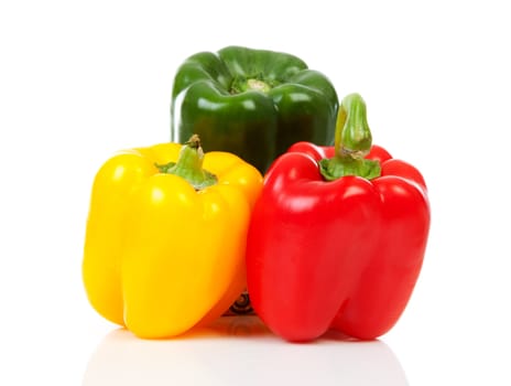 Three fresh paprika ( red, yellow and green) over white background 
