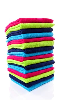 Pile of colorful towels over white background