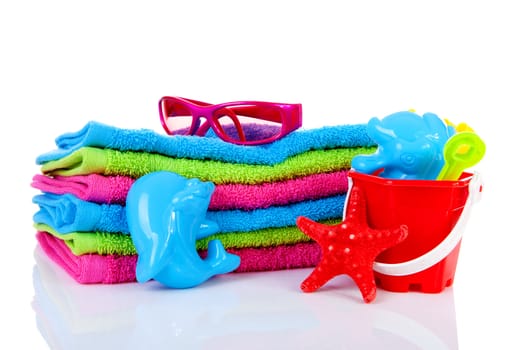 beach accessories, towels, toys and starfish over white background