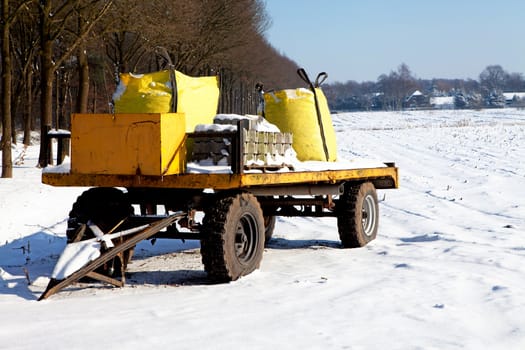 Loaded farm wagon in Dutch winter landscape