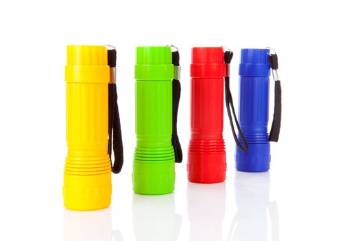 Four colorful flashlights in a row over white background