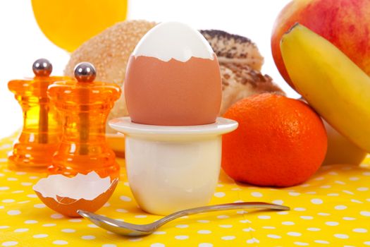 Breakfast with peeled egg, delicious bread and fruits in closeup