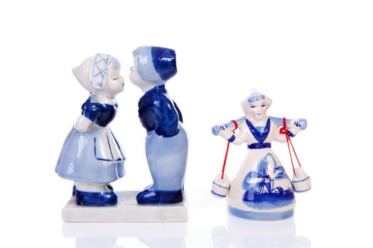 Two Dutch souvenir statues over white background