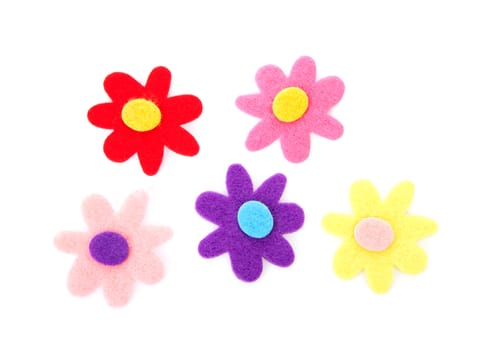 Five colorful felt flowers over white background